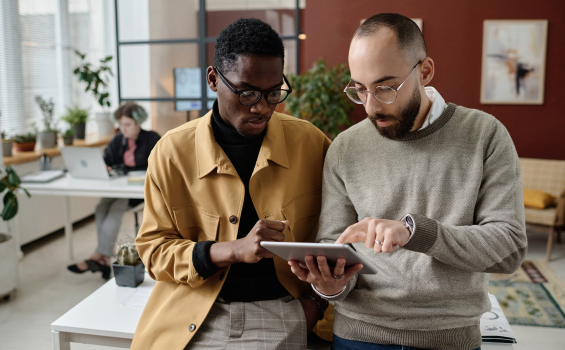 Male colleagues working with electronic device