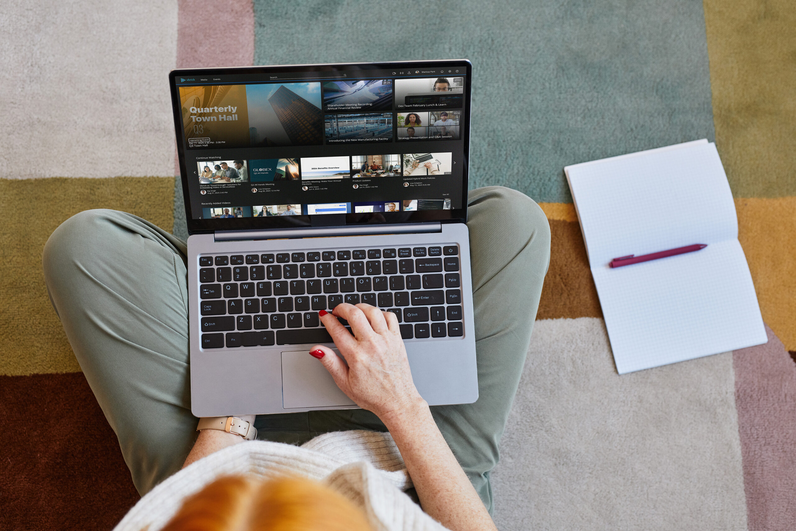 Overhead view of person working at a laptop sitting on a couch