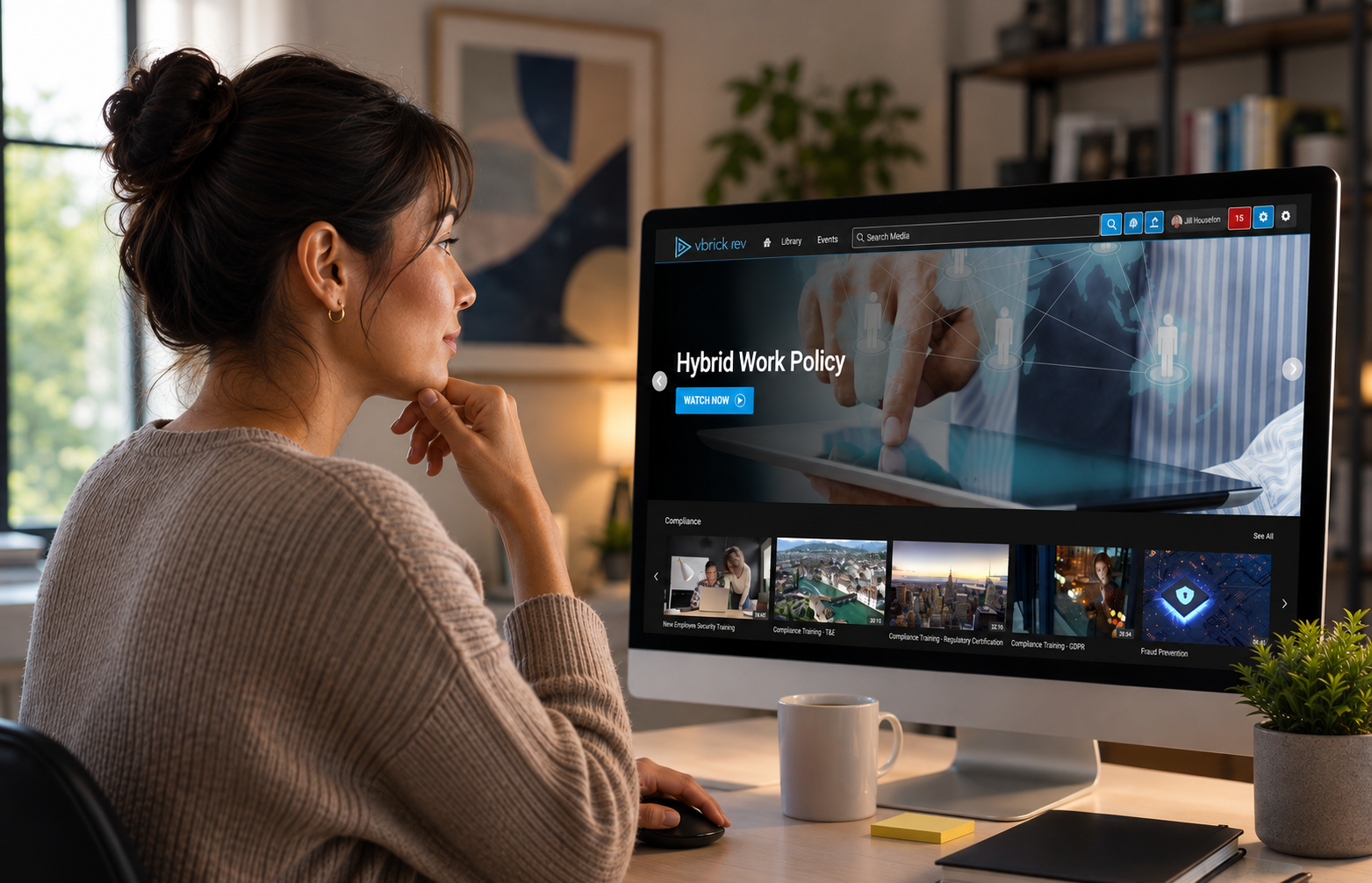Woman works on managing video content files in a home office