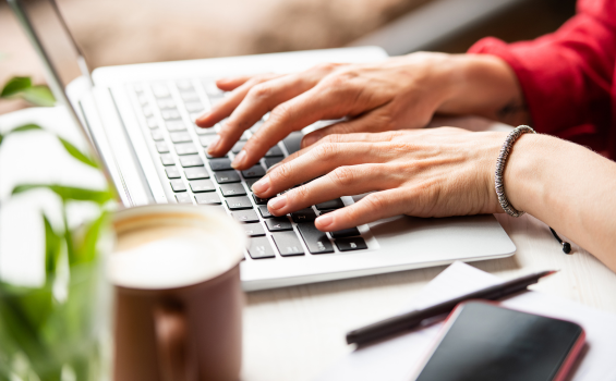 Young woman's hands typing on a keyboard