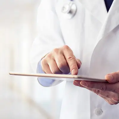 Doctors hand pointing at something on a tablet