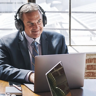 Man with headphones on a laptop