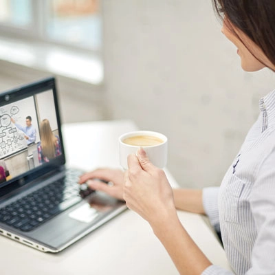 Woman on her laptop, watching a training video
