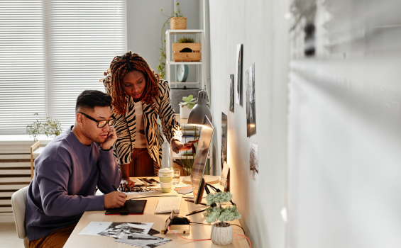 Colleagues work on digital content in an office