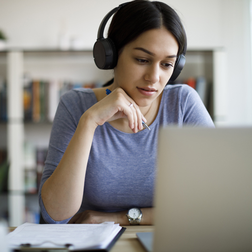 Young woman with headphones working from home